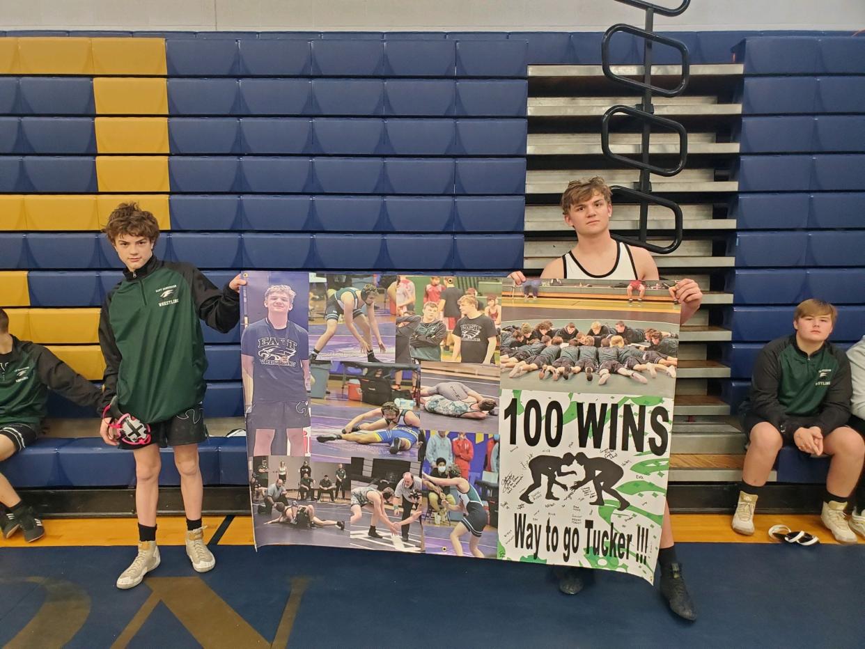 East Henderson's Tucker Marshall, right, got his 100th career victory with a win against Enka at the TC Roberson Ram Duals on Saturday. With him is his younger brother, Gunner.