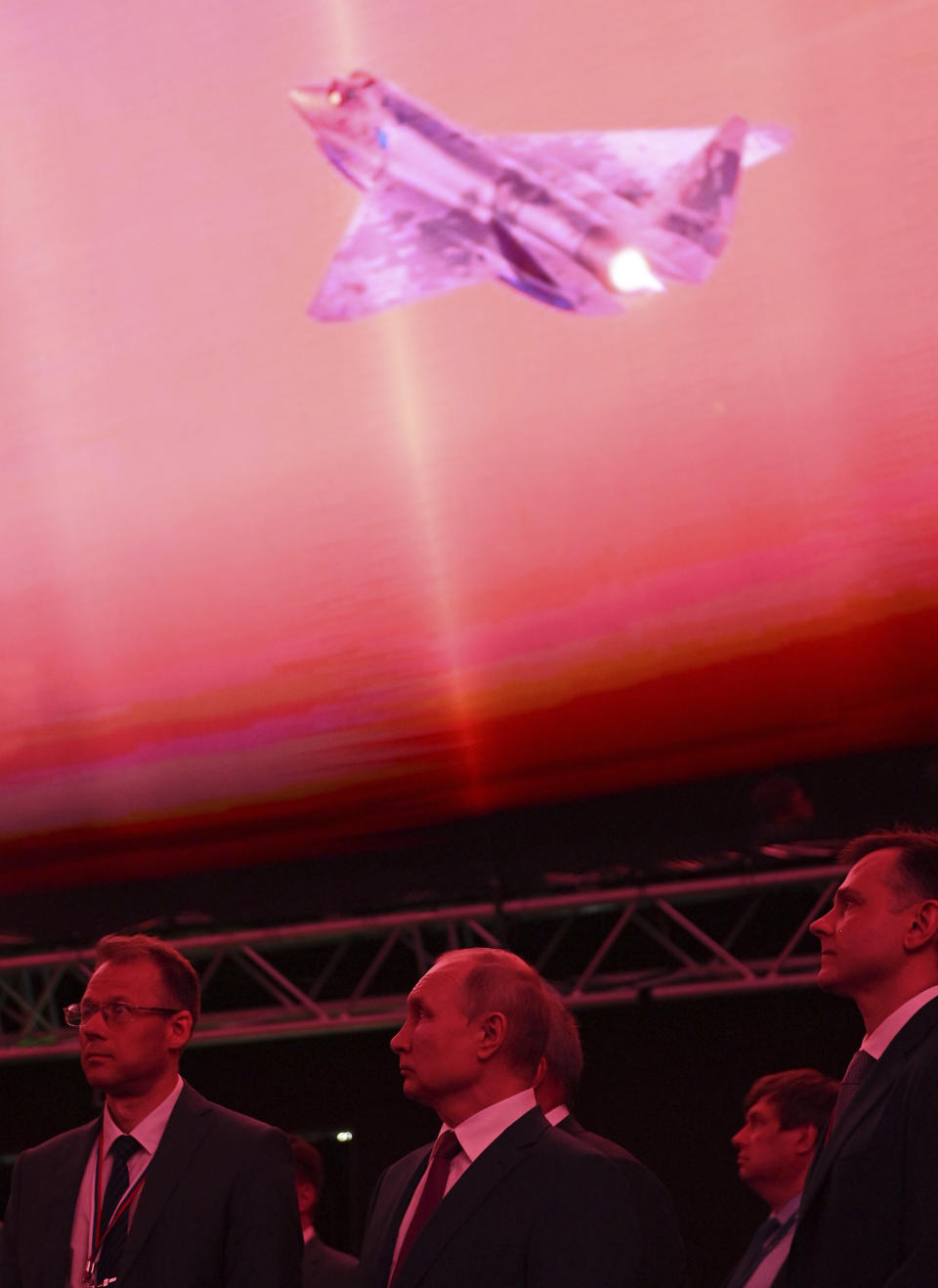 Russian President Vladimir Putin, center, inspects a prototype of a new fighter jet that features stealth capabilities and other advanced characteristics at the MAKS-2021 International Aviation and Space Salon outside Zhukovsky, Russia, Tuesday, July 20, 2021. (Alexei Nikolsky, Sputnik, Kremlin Pool Photo via AP)