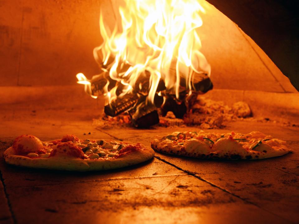 Pizzas bake at Russo's Wood Fired Pizza in Zanesville. The restaurant, located on Maple Avenue, is among the many that has been forced to raise prices due to rapid inflation of supply costs within the industry.