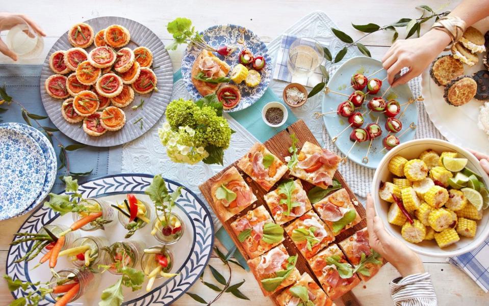 mozzarella red pepper bacon skewers arranged on a light blue oval plate