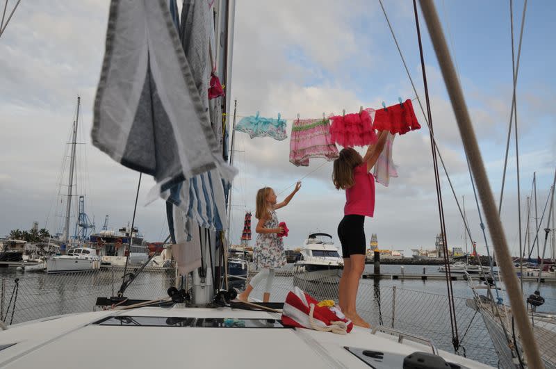 Katalin and Boroka hang clothes to dry on the sailing boat 'Teatime' in Las Palmas