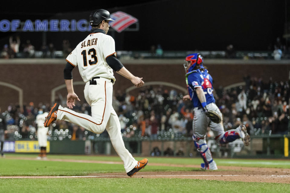 San Francisco Giants' Austin Slater (13) scores a run against the Texas Rangers during the seventh inning of a baseball game in San Francisco, Monday, May 10, 2021. (AP Photo/John Hefti)