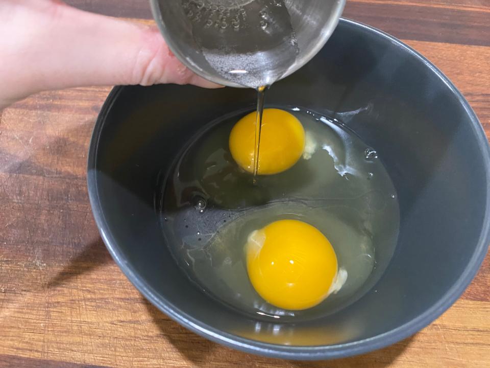 paige pouring seltzer water into a bowl with two cracked eggs