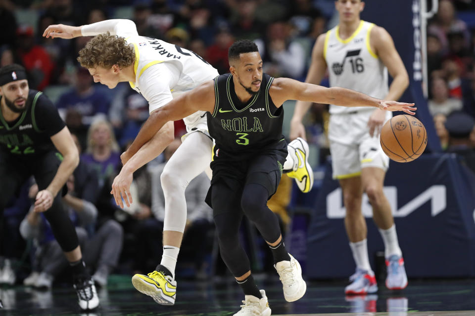 New Orleans Pelicans guard CJ McCollum (3) steals the ball from Utah Jazz forward Lauri Markkanen (23) during the first half of an NBA basketball game in New Orleans, Tuesday, Jan. 23, 2024. (AP Photo/Tyler Kaufman)