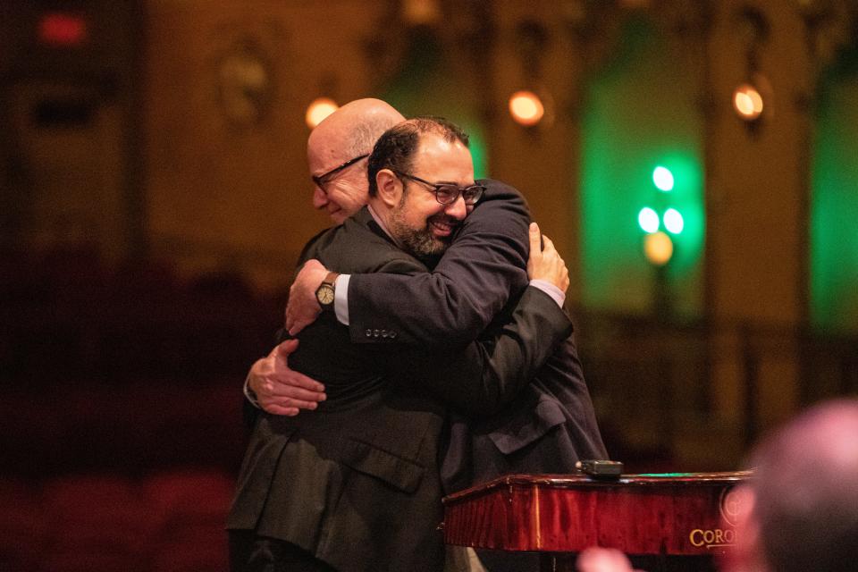 Yaniv Attar, left, hugs Dr. Arnie Rosen on Wednesday, Jan. 18, 2023, at Coronado Performing Arts Center in Rockford. Attar was named the new music director for the Rockford Symphony Orchestra.