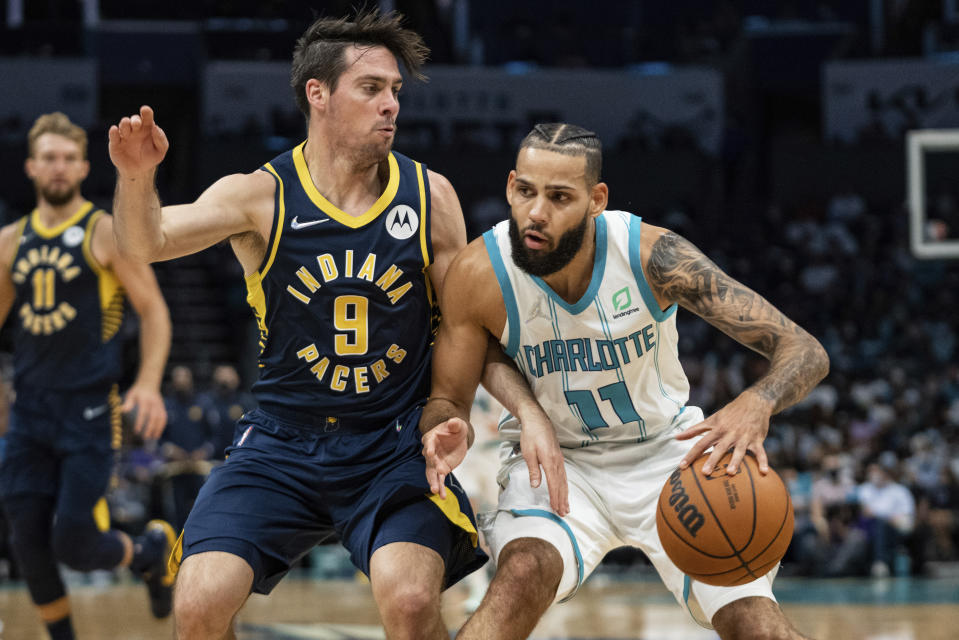Charlotte Hornets forward Cody Martin (11) works against Indiana Pacers guard T.J. McConnell (9) during the first half of an NBA basketball game in Charlotte, N.C., Wednesday, Oct. 20, 2021. (AP Photo/Jacob Kupferman)