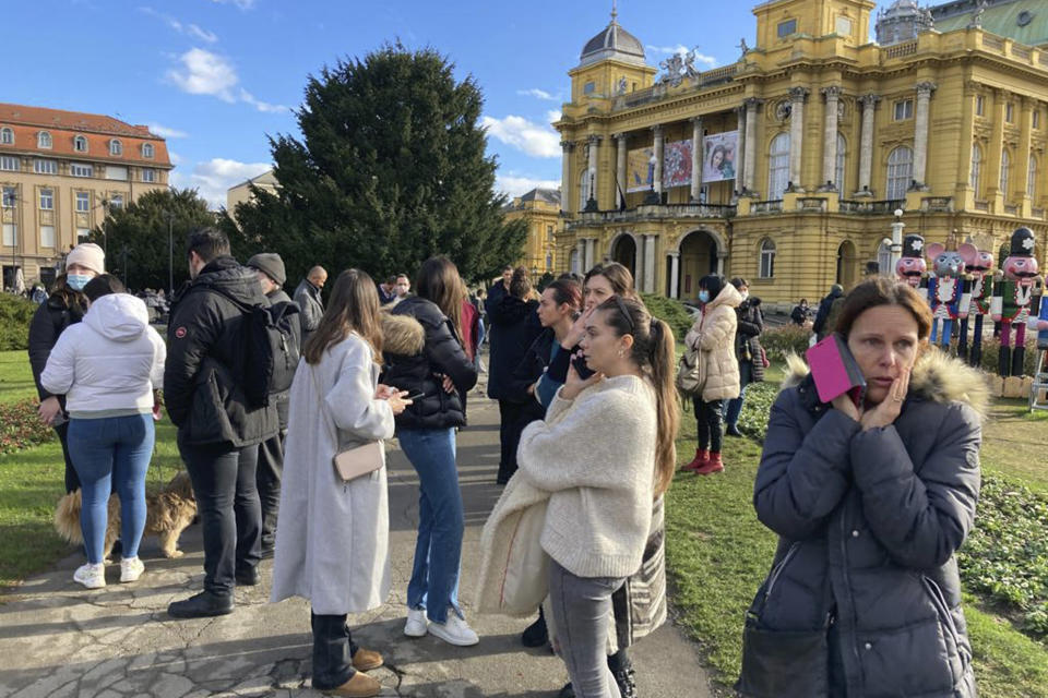 Residents gather outside after an earthquake, at a square in downtown Zagreb, Croatia, Tuesday, Dec. 29, 2020. A strong earthquake hit Croatia on Tuesday, with some injuries reported as well as considerable damages to roofs and buildings southeast of the capital. (AP Photo/Filip Horvat)