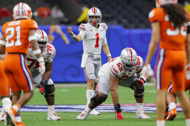 Justin Fields of the Ohio State Buckeyes looks on in the first