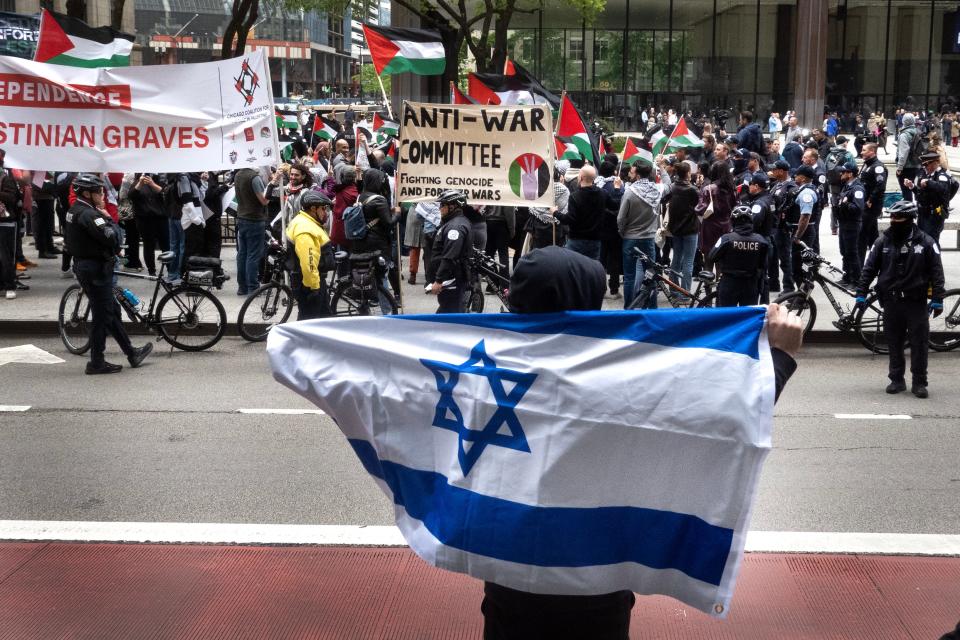 A supporter of Israel taunts a group of pro-Palestinian activists demonstrating near an Israeli Independence Day celebration in Daley Center Plaza on May 14, 2024 in Chicago, Illinois.