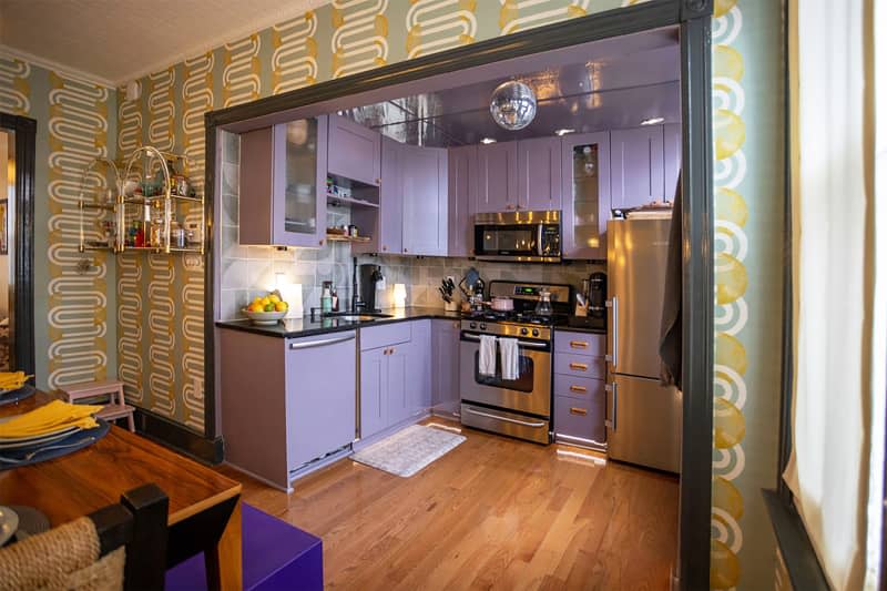 Purple cabinets in renovated kitchen with disco ball on ceiling