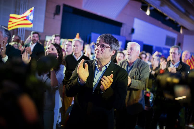 Former regional president Carles Puigdemont applauds during a campaign rally in Argelers, France, Wednesday, May 8, 2024.