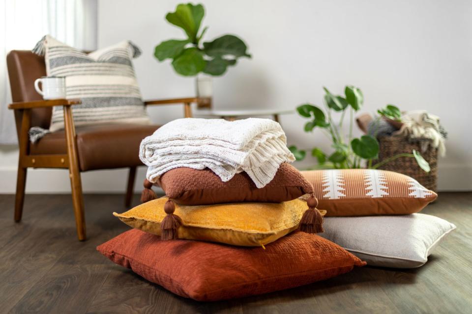 fall pillows and blanket stacked up