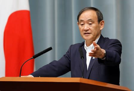 FILE PHOTO: Japan's Chief Cabinet Secretary Suga attends a news conference at Prime Minister Shinzo Abe's official residence in Tokyo