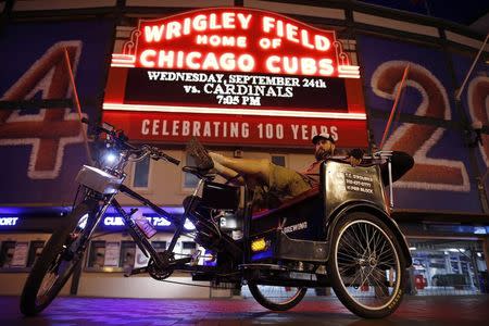 T.C. O'Rourke sits in his pedicab outside Wrigley Field in the Wrigleyville neighborhood in Chicago, Illinois, September 19, 2014. REUTERS/Jim Young