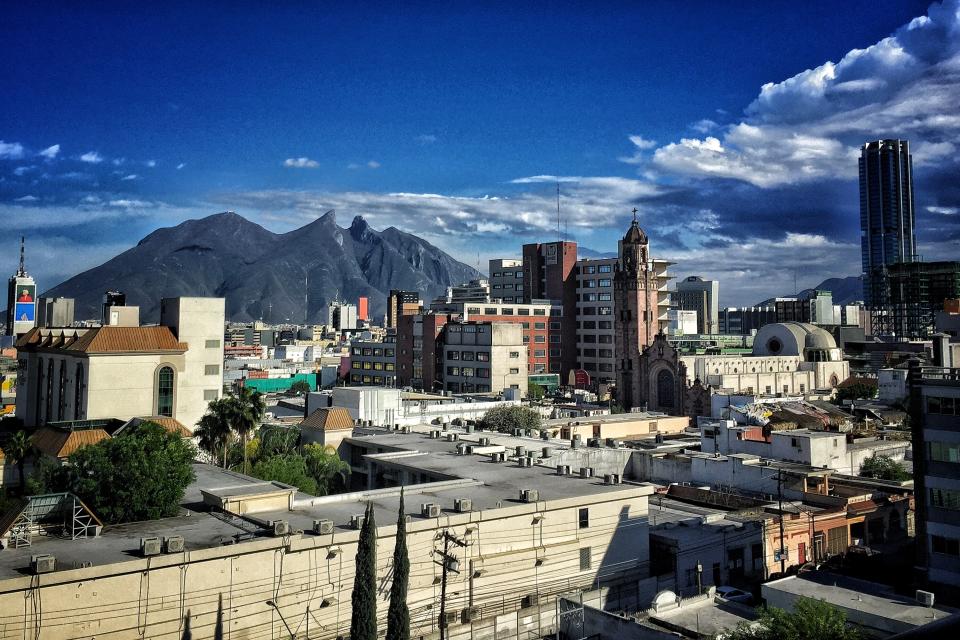 Townscape By Mountain Against Sky