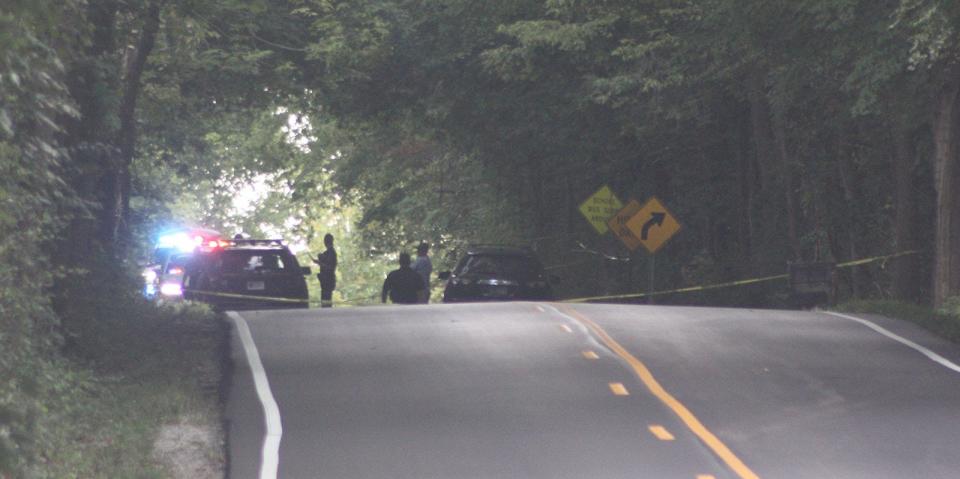 Yellow tape is strewn across Mann Road on Sept. 13, 2019, as Morgan County investigators gather at the scene where Alexander Jackson's body was found. (Keith Rhoades/Reporter-Times)