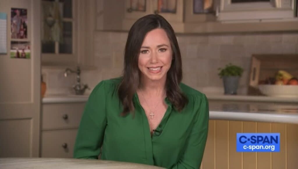 Katie Britt in a green shirt in a kitchen