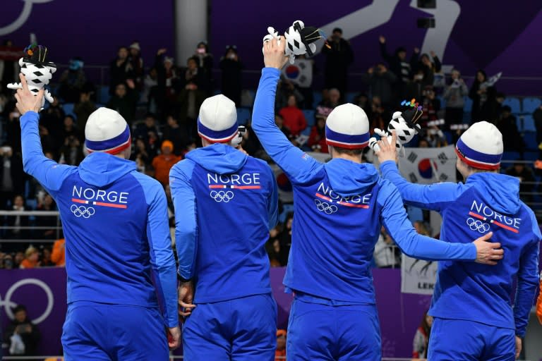 The Norwegian men's pursuit speed skating team celebrate at the Pyeongchang 2018 Winter Olympic Games, which have Norwegians back home hooked and often watching events on TV even during work time
