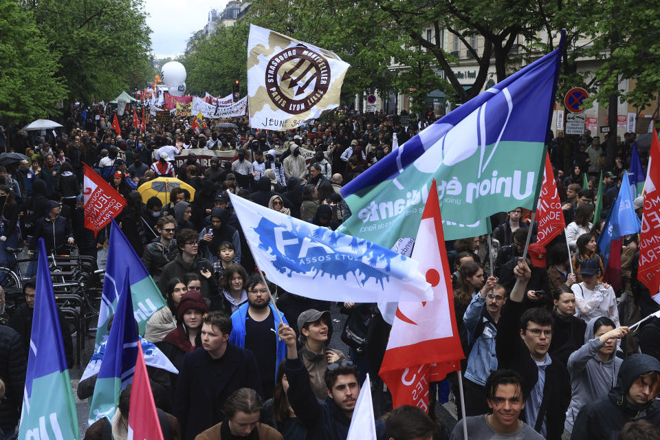 Protesters march during a demonstration, Monday, May 1, 2023 in Paris. Across France, thousands marched in what unions hope are the country's biggest May Day demonstrations in years, mobilized against President Emmanuel Macron's recent move to raise the retirement age from 62 to 64. (AP Photo/Aurelien Morissard)