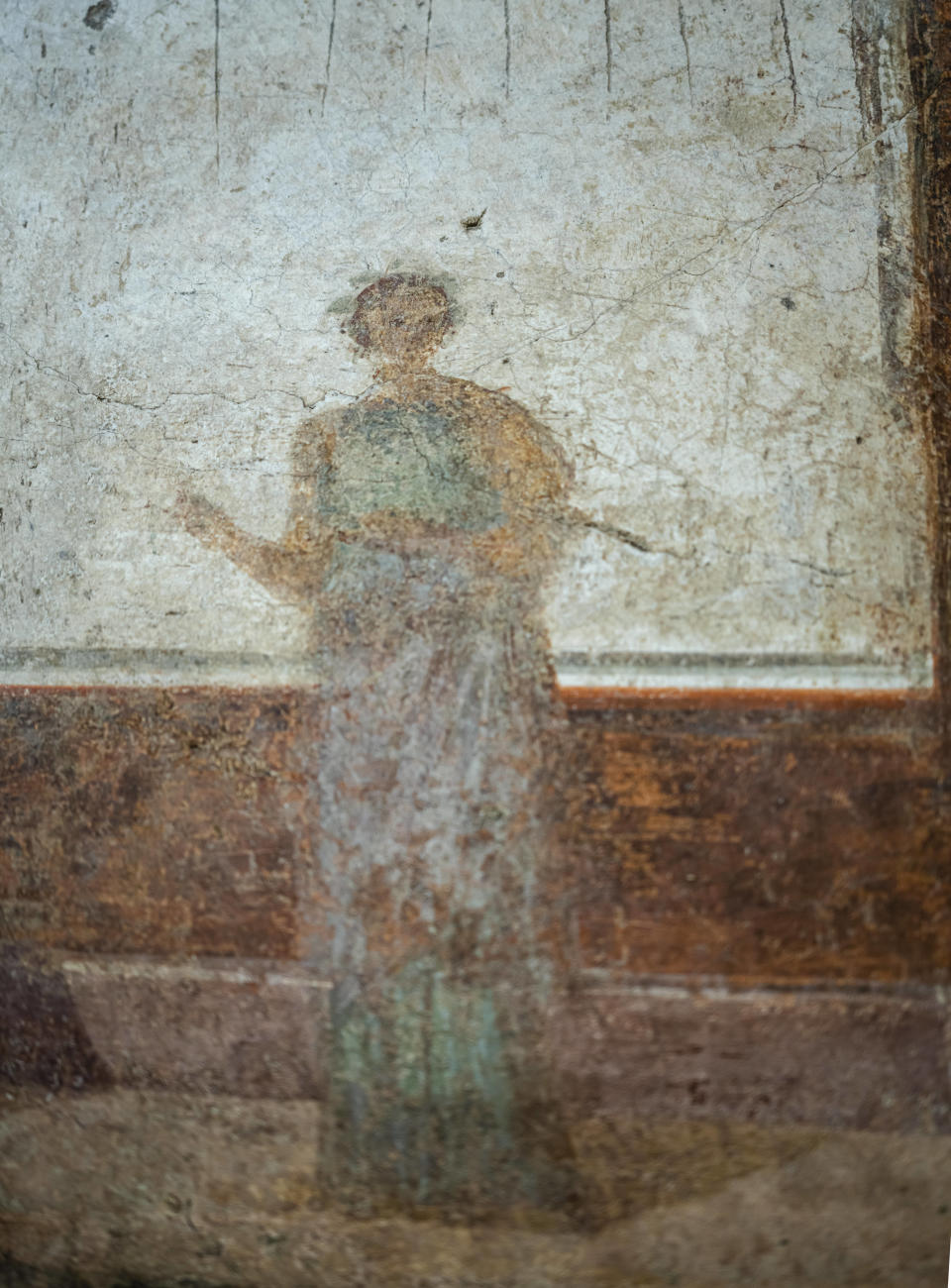 A detail of the frescoes coming from the sacellum, a small votive chapel, of a two-story home, or "Domus," dating from around 134-138 AD that was partially destroyed to make way for the construction of the Caracalla public baths, which opened in 216 AD, are on display at the Caracalla archaeological park in Rome, Thursday, June 23, 2022. The frescoed ceiling and walls of a domestic temple honoring Greco-Roman and Egyptian religious deities and believed to have belonged to a wealthy merchant family were first discovered in the mid-19th century about 10 meters (yards) underneath the current ground level of the baths, had been briefly exhibited but has been closed to the public for 30 years. (AP Photo/Domenico Stinellis)