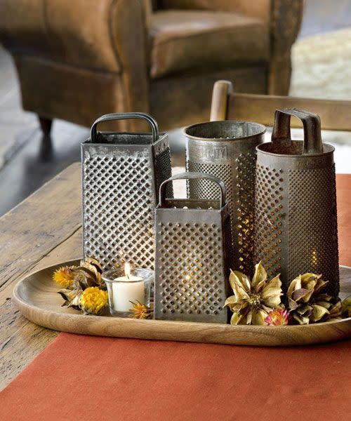 <p>Cast twinkling light across the tabletop with a collection of these yard sale finds. When the lights do down, the cheese grater creates a glimmering effect.</p>