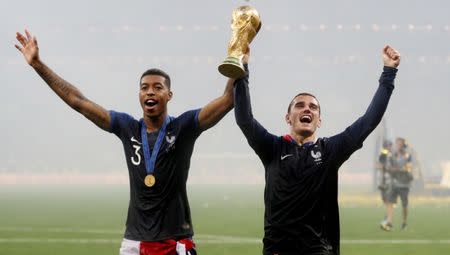 Soccer Football - World Cup - Final - France v Croatia - Luzhniki Stadium, Moscow, Russia - July 15, 2018 France's Presnel Kimpembe and Antoine Griezmann celebrate with the trophy after winning the World Cup REUTERS/Carl Recine