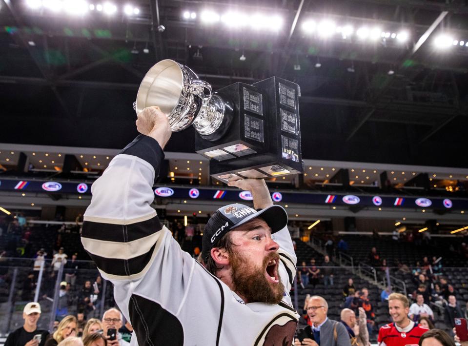 Hershey defenseman Dylan McIlrath (42) celebrates with the Calder Cup trophy after Game 7 of the Calder Cup Finals at Acrisure Arena in Palm Desert, Calif., Wednesday, June 21, 2023. 