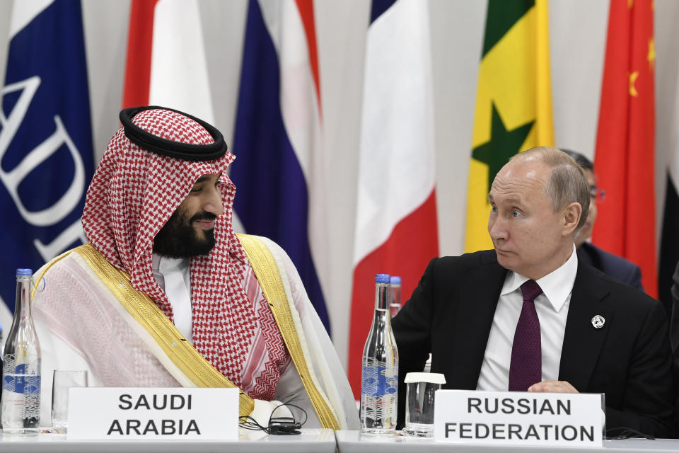 Saudi Arabia's Crown Prince Mohammed bin Salman, left, talks with Russian President Vladimir Putin, right, during the G-20 summit event on the Digital Economy in Osaka, Japan, Friday, June 28, 2019. (AP Photo/Susan Walsh)