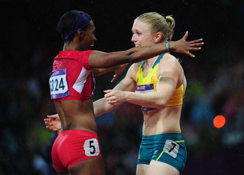 LONDON, ENGLAND - AUGUST 07: Sally Pearson of Australia hugs Kellie Wells of the United States after winning the gold medal in the Women's 100m Hurdles Final on Day 11 of the London 2012 Olympic Games at Olympic Stadium on August 7, 2012 in London, England. (Photo by Stu Forster/Getty Images)