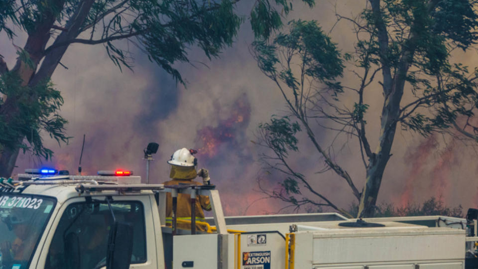 Firefighters near the scene of a bushfire in Perth