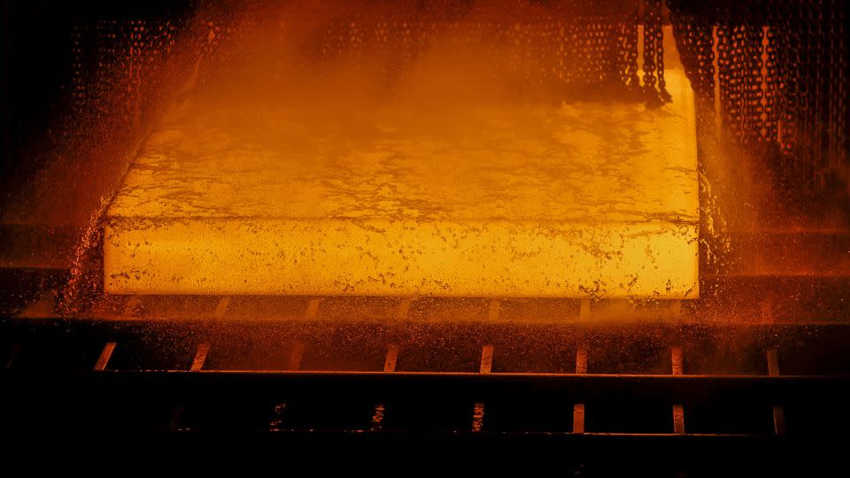 A red hot steel slab passes through a rolling machine inside the hot strip mill unit at the Rourkela Steel Plant in Odisha, India, on Friday, June 21, 2019. - Dhiraj Singh/Bloomberg/Getty Images