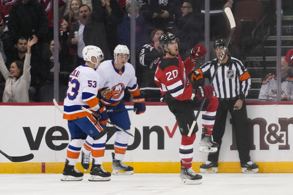 New Jersey Devils' Michael McLeod (20), right, reacts after scoring during the first period of an NHL hockey game against the New York Islanders in Newark, N.J., Tuesday, Nov. 28, 2023. (AP Photo/Seth Wenig)