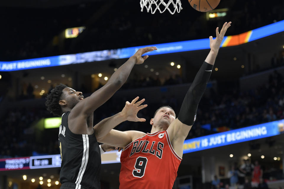 Chicago Bulls center Nikola Vucevic (9) shoots against Memphis Grizzlies forward Jaren Jackson Jr. during the first half of an NBA basketball game Thursday, Feb. 8, 2024, in Memphis, Tenn. (AP Photo/Brandon Dill)