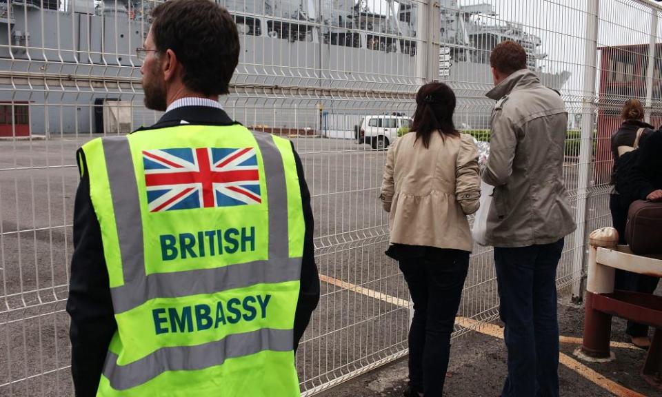 Man wears British embassy vest at the ferry terminal at Santander, Spain.