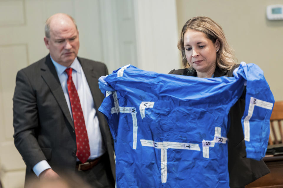 SLED agent Kristin Moore, right, displays a rain jacket during the double murder trial of Alex Murdaugh at the Colleton County Courthouse in Walterboro, S.C., on Monday, Feb. 6, 2023. Behind her is defense attorney Jim Griffin. The 54-year-old attorney is standing trial on two counts of murder in the shootings of his wife and son at their Colleton County home and hunting lodge on June 7, 2021. (Jeff Blake/The State via AP, Pool)