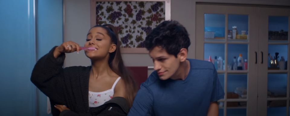 Ariana Grande brushing her teeth next to a guy