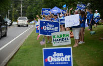 <p>Supporters for Georgia 6th Congressional District Democratic candidate Jon Ossoff rally and wave at passing cars amid signs for Republican candidate Karen Handel outside St Mary’s Orthodox Church, Handel’s polling place in Roswell, Georgia, U.S., June 20, 2017. (Photo: Bita Honarvar/Reuters) </p>