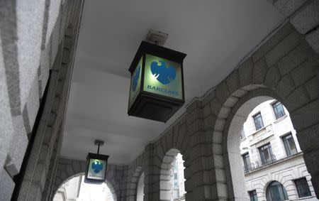 FILE PHOTO: The logo of Barclays bank is seen on glass lamps outside of a branch of the bank in the City of London financial district in London September 4, 2017. REUTERS/Toby Melville/File Photo