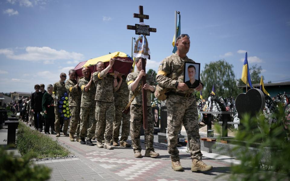 Ukrainian soldiers carry the coffin of Roman Tkachenko, aged 21 who was killed fighting the Russian invasion near Kharkiv on June 04, 2022 - Christopher Furlong/Getty Images Europe