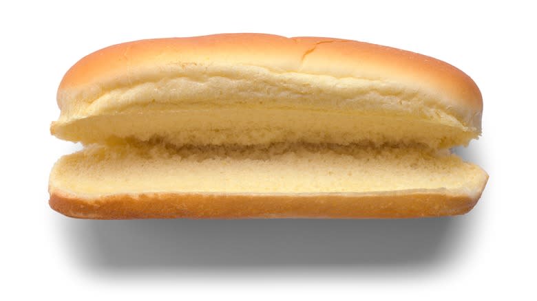 Hot dog bun against white