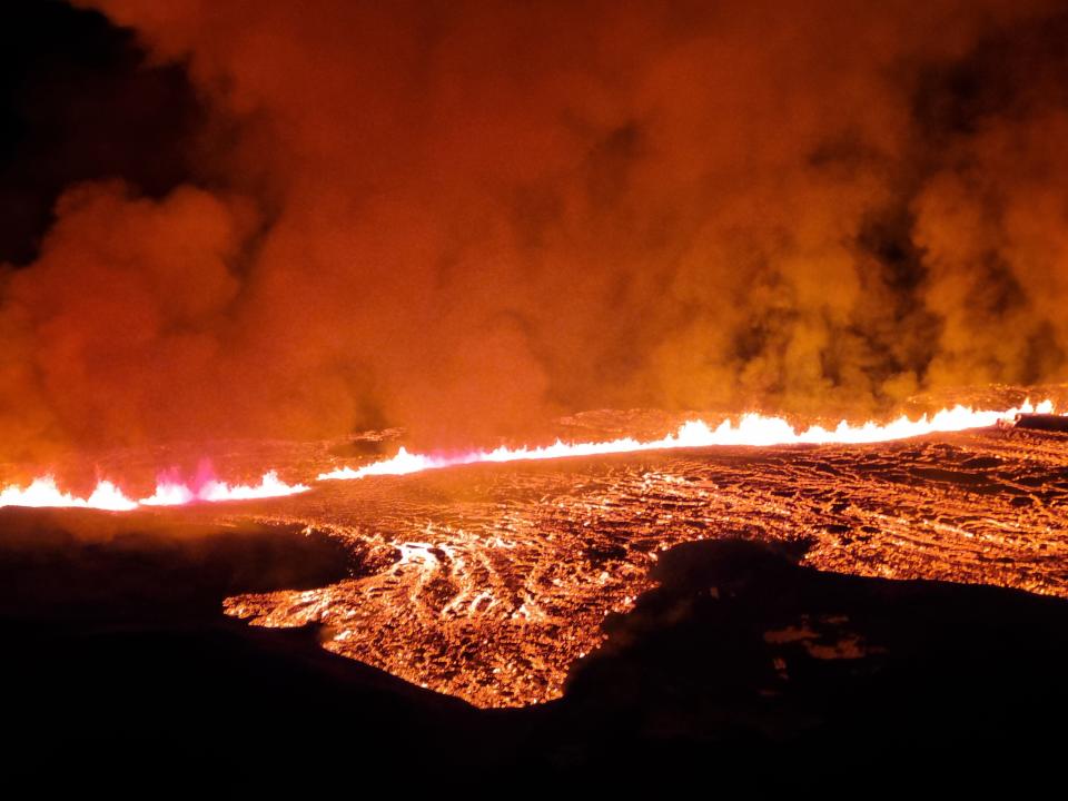 GRINDAVIK, ICELAND - JANUARY 14: In this handout photo provided by the Iceland Coast Guard, lava is seen spewing from a volcano on Iceland's Reykjanes Peninsula after its eruption on January 14, 2024 near Grindavik, Iceland. On Sunday morning, a new eruption happened north of Grindavik in southwestern Iceland, causing residents to evacuate due to increased seismic activity around 03:00 GMT. The alert level is now at 