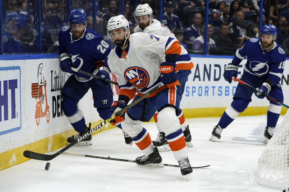 New York Islanders right wing Jordan Eberle (7) clears the puck away from Tampa Bay Lightning center Blake Coleman (20) during the second period in Game 2 of an NHL hockey Stanley Cup semifinal playoff series Tuesday, June 15, 2021, in Tampa, Fla. (AP Photo/Chris O'Meara)