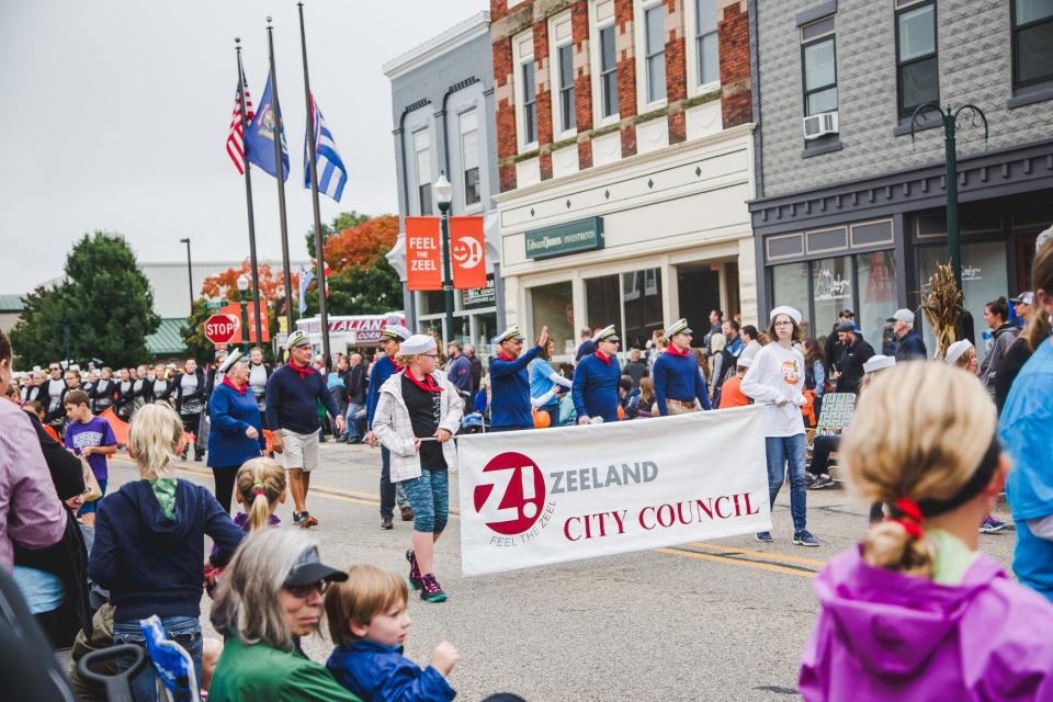 Zeeland City Council representatives parade down Main Street during Pumpkinfest.