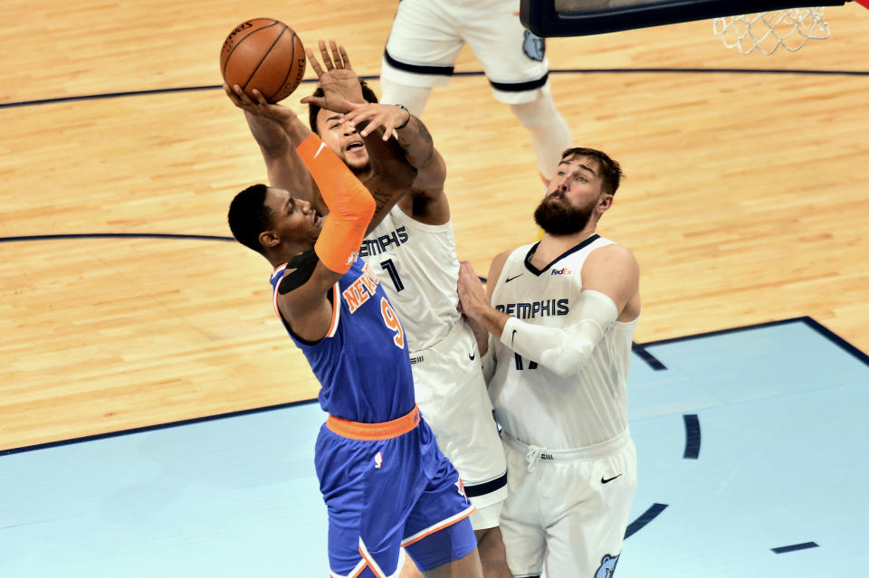 New York Knicks guard RJ Barrett (9) shoots against Memphis Grizzlies forward Kyle Anderson (1) and center Jonas Valanciunas in the second half of an NBA basketball game Monday, May 3, 2021, in Memphis, Tenn. (AP Photo/Brandon Dill)