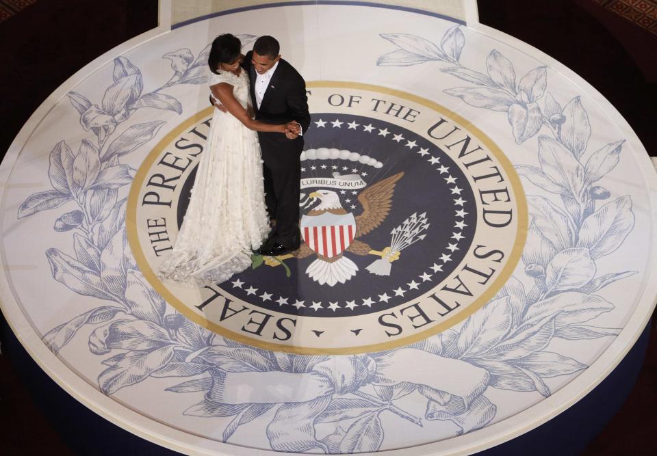 FILE - In this Jan. 20, 2009, file photo, President Barack Obama and first lady Michelle Obama dance at the Commander in Chief Inaugural Ball at the National Building Museum in Washington. Obama's second inauguration is shaping up as a high-energy celebration smaller than his first milestone swearing-in, yet still designed to mark his unprecedented role in American history with plenty of eye-catching glamour. A long list of celebrity performers will give the once-every-four years right of democratic passage the air of a star-studded concert, from the bunting-draped Capitol's west front of the Capitol, where Obama takes the oath Jan. 21, to the Washington Convention Center, which is expected to be packed with 40,000 ball-goers that evening. (AP Photo/Charles Dharapak, File)