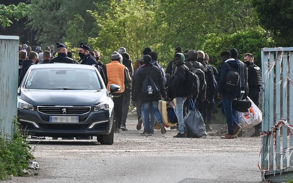 Police supervise the evacuation of a migrant camp on the road to Saint-Omer near Calais - AFP