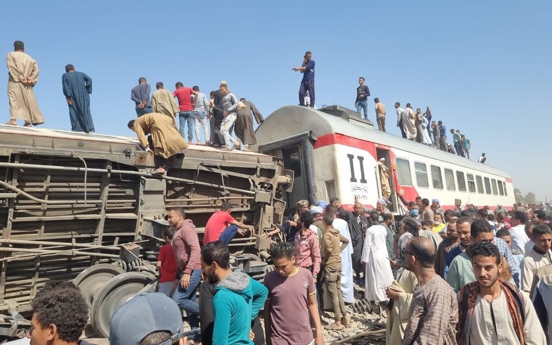 People gather to inspect damaged train cars after two passenger trains collided near Tahta in Egypt - Mahmoud Maqboul/DPA/Cover Images 