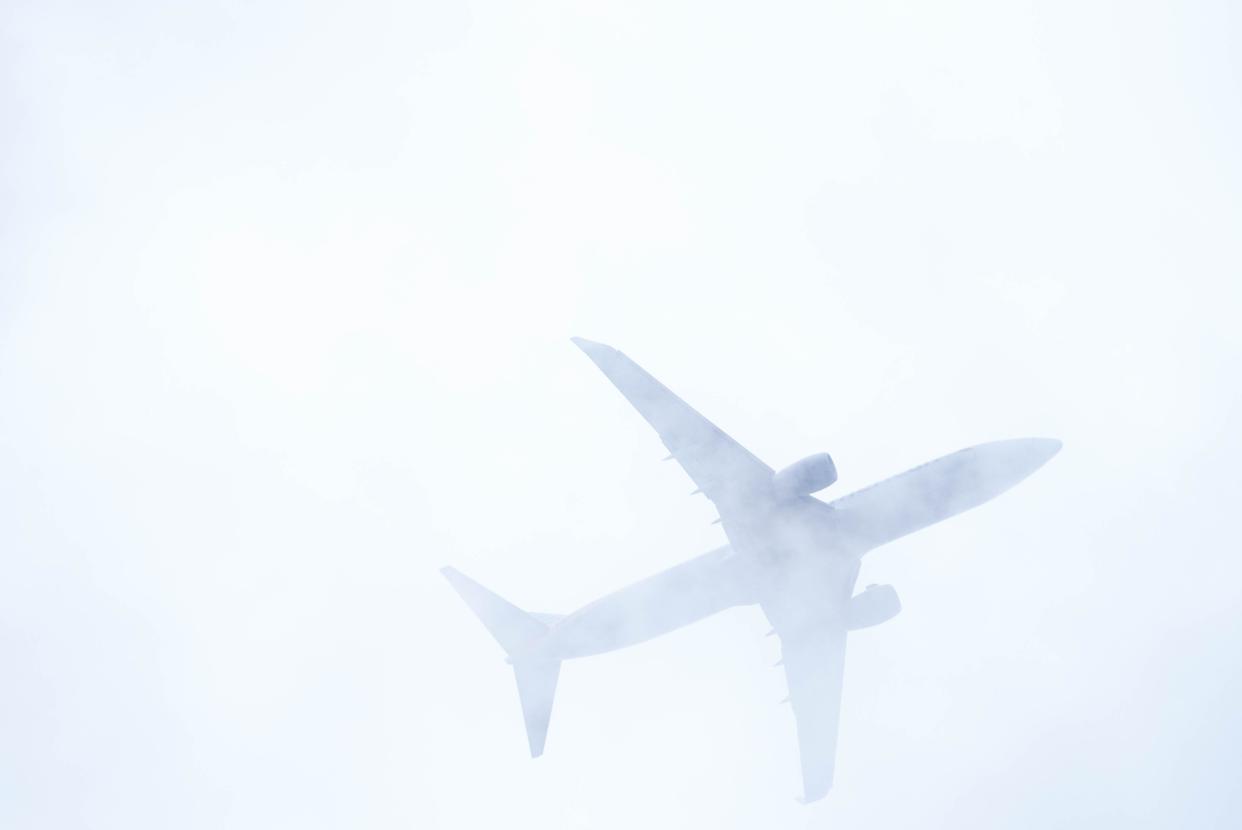 An airplane flies above Tempe Town Lake on Dec. 30, 2022.