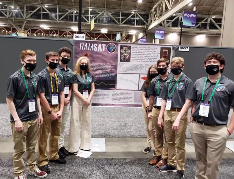 Students present the RamSat poster at the December 2021 meeting of the American Geophysical Union.