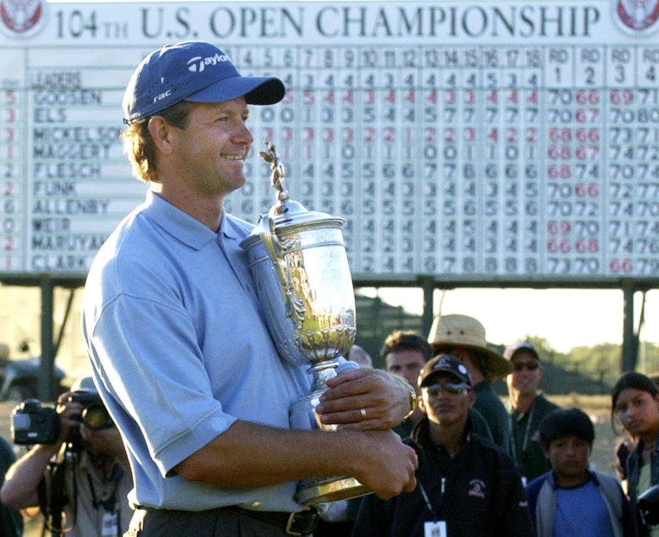 FILE - Retief Goosen, of South Africa, holds the U.S. Open Championship trophy, June 20, 2004, at Shinnecock Hills Golf Club in Southampton, N.Y. Twenty years ago this week, Goosen won his second U.S. Open title. (AP Photo/Charles Krupa, file)